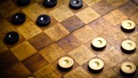 Genius and Conway's Infinite Checkers Problem